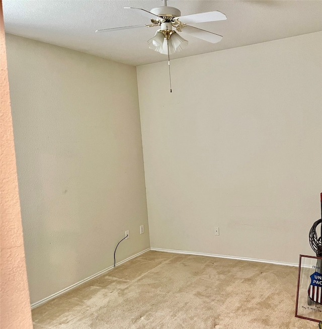 unfurnished room featuring light carpet, a textured ceiling, and ceiling fan