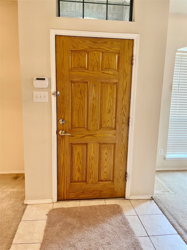 entryway featuring light carpet