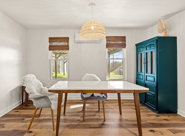 dining room with a wall unit AC and wood-type flooring