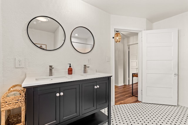 bathroom featuring double sink vanity and hardwood / wood-style floors