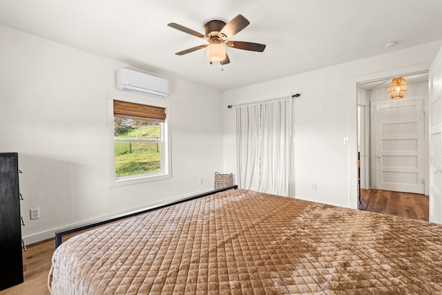 bedroom featuring ceiling fan, a wall mounted air conditioner, and hardwood / wood-style floors