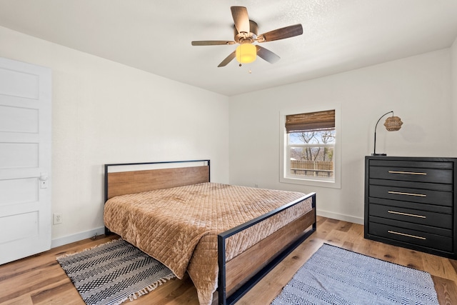 bedroom featuring ceiling fan and light hardwood / wood-style flooring