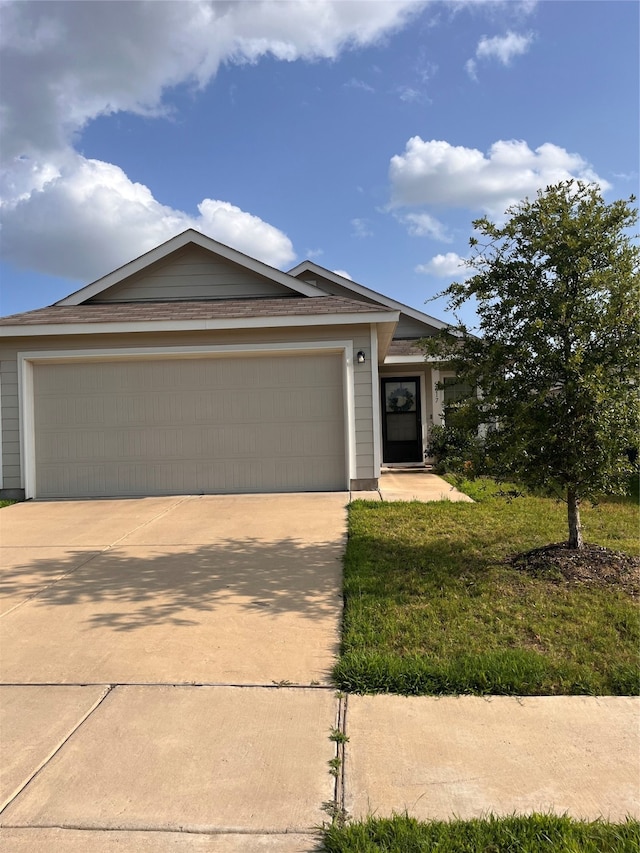 view of front of property with a front lawn and a garage