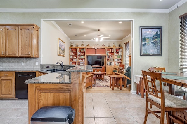 kitchen with kitchen peninsula, dark stone countertops, backsplash, ornamental molding, and sink