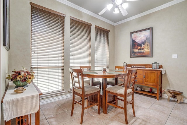 dining room with ceiling fan, light tile patterned floors, and crown molding