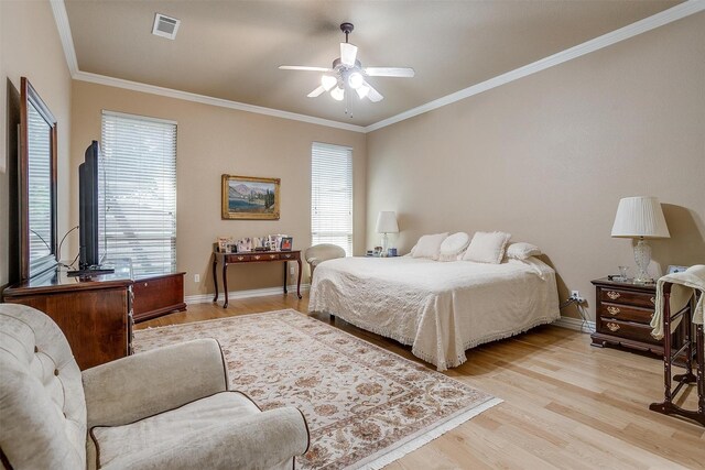 bedroom featuring ceiling fan, ornamental molding, and light hardwood / wood-style floors