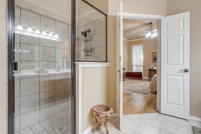 bathroom featuring ceiling fan, walk in shower, hardwood / wood-style flooring, and ornamental molding