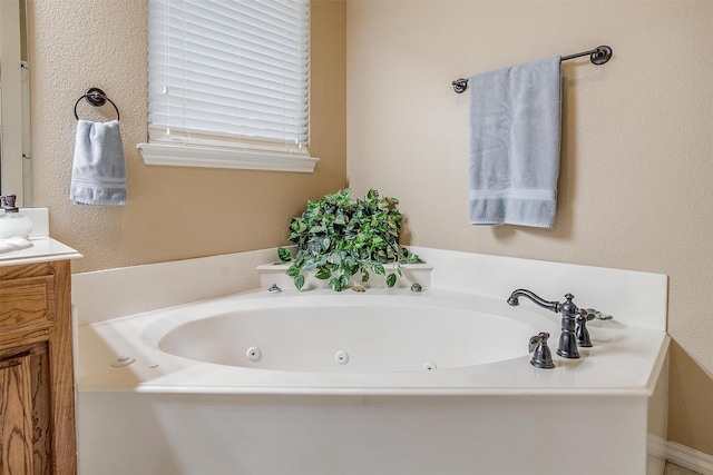 bathroom featuring a tub and vanity