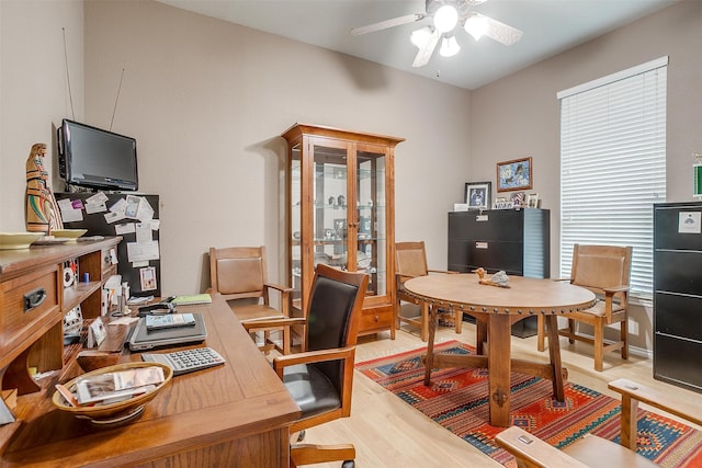 home office with ceiling fan and light wood-type flooring