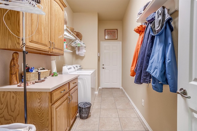 washroom with independent washer and dryer, light tile patterned flooring, and cabinets