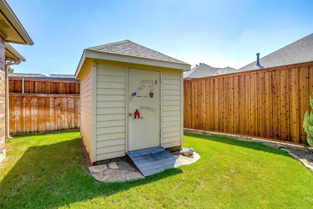 view of outbuilding with a yard