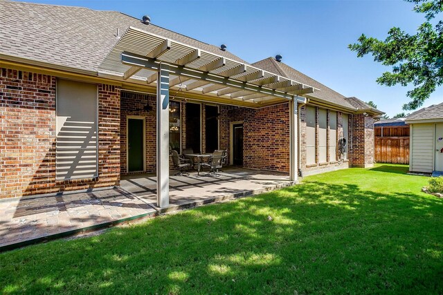 rear view of house featuring a pergola, a lawn, and a patio