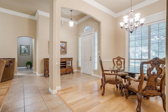 interior space featuring a notable chandelier, light hardwood / wood-style flooring, and crown molding