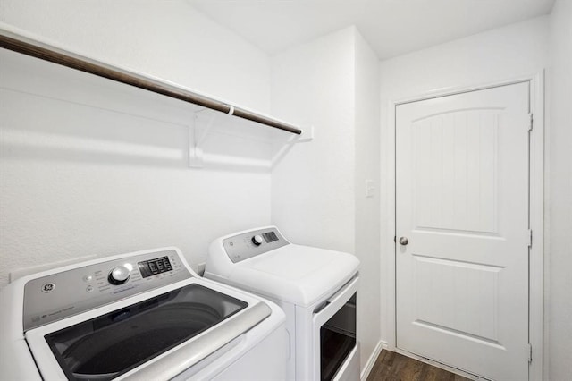 washroom featuring independent washer and dryer and dark wood-type flooring