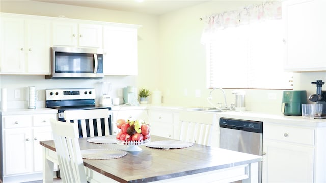 kitchen featuring sink, white cabinetry, and appliances with stainless steel finishes