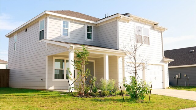 view of front of property featuring a front lawn and a garage