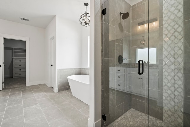 bathroom featuring tile walls, separate shower and tub, and tile patterned floors