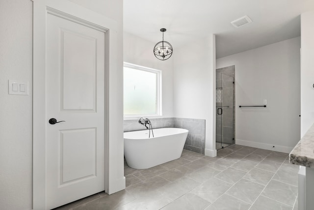 bathroom with a chandelier, separate shower and tub, and tile patterned flooring