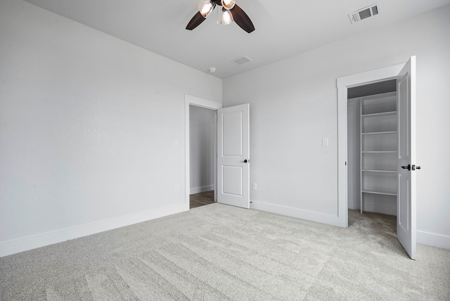 unfurnished bedroom with light colored carpet and ceiling fan