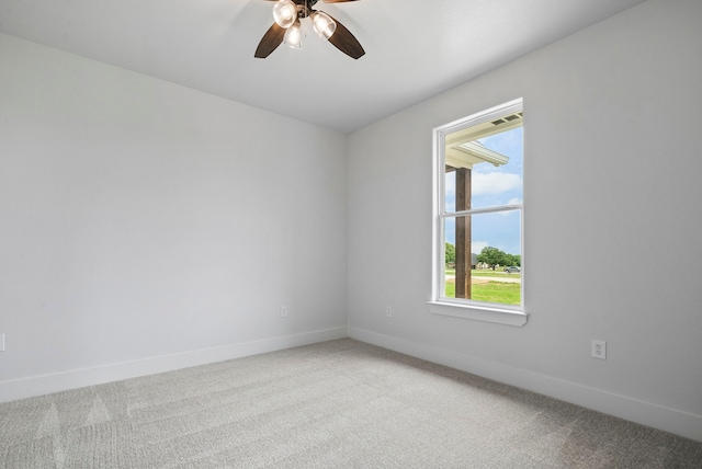 carpeted spare room with ceiling fan