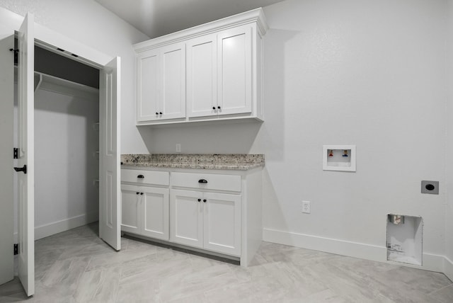 clothes washing area featuring cabinets, washer hookup, and electric dryer hookup