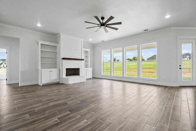 unfurnished living room featuring dark hardwood / wood-style floors, a fireplace, and a wealth of natural light