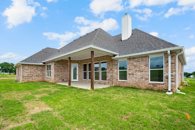 back of property featuring a yard and a patio area