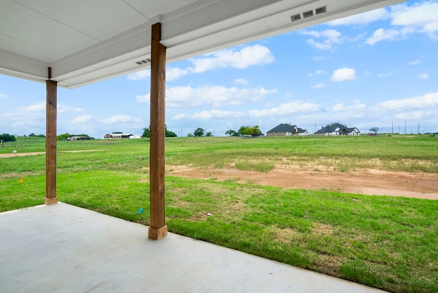 view of yard with a patio area and a rural view