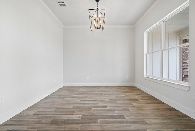 unfurnished room featuring a notable chandelier, hardwood / wood-style flooring, and crown molding