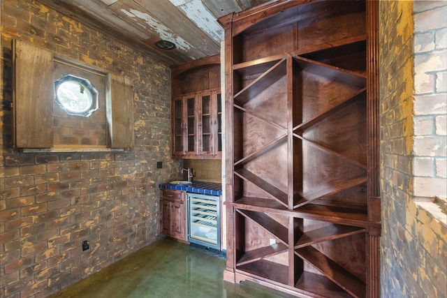 wine cellar with beverage cooler and brick wall