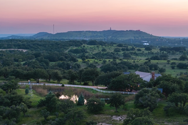 aerial view at dusk featuring a mountain view