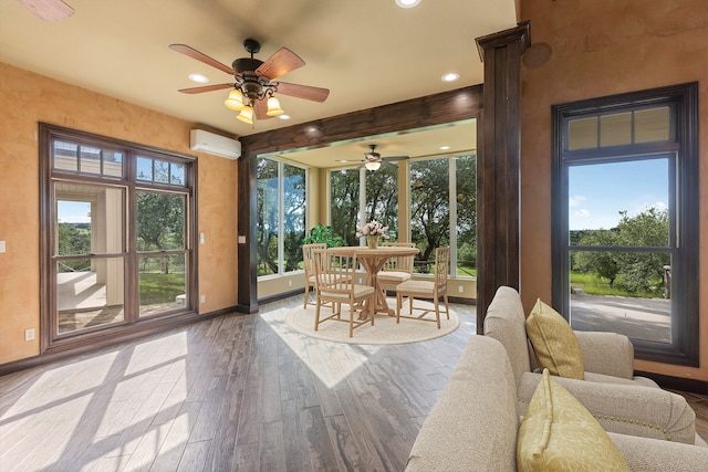 sunroom featuring ceiling fan and a wall mounted air conditioner