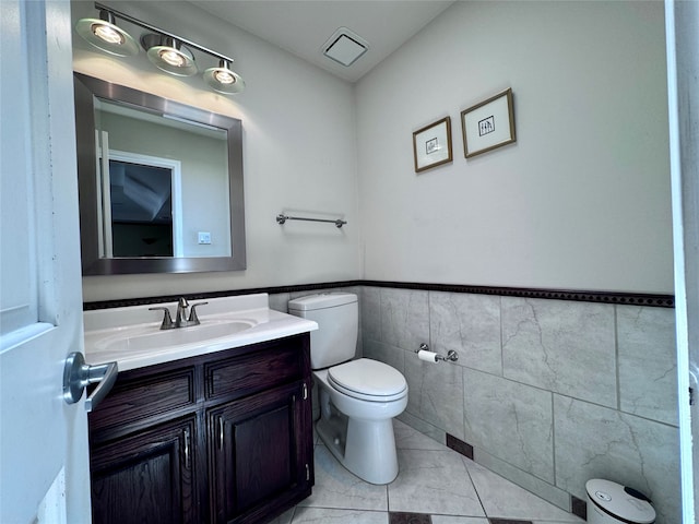 bathroom featuring tile walls, tile patterned flooring, vanity, and toilet