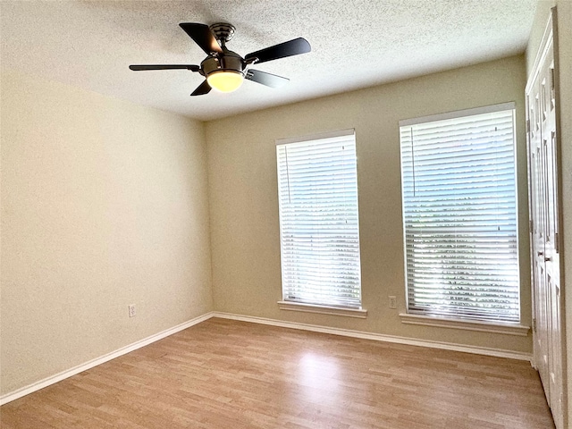 unfurnished room featuring hardwood / wood-style flooring, a textured ceiling, and ceiling fan