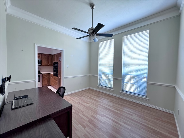 office with a wealth of natural light, light hardwood / wood-style flooring, ceiling fan, and ornamental molding