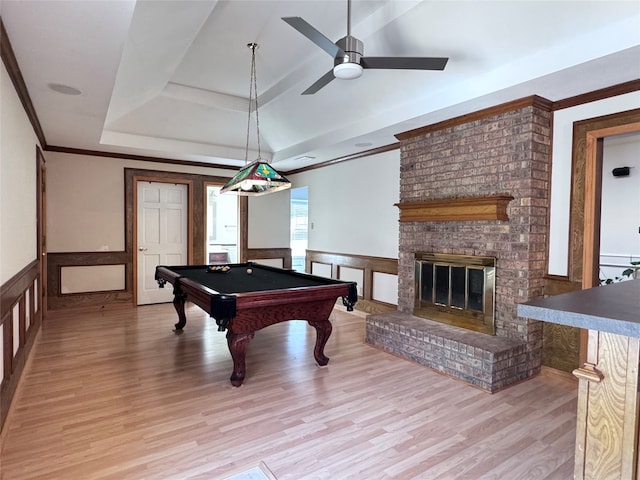 playroom with ceiling fan, a raised ceiling, pool table, light hardwood / wood-style flooring, and a fireplace