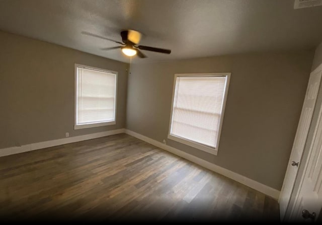 empty room featuring ceiling fan and dark hardwood / wood-style floors