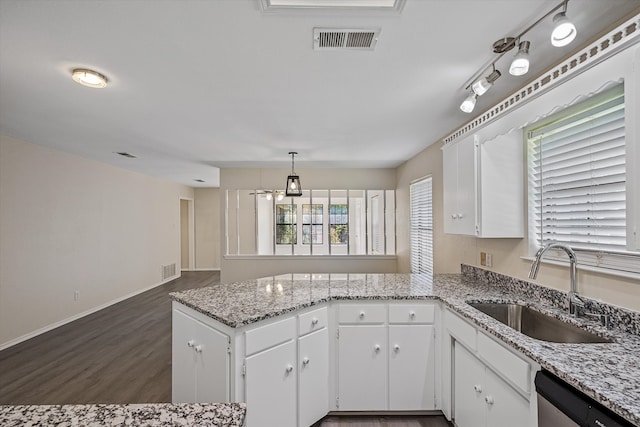 kitchen with dishwasher, rail lighting, dark hardwood / wood-style floors, sink, and white cabinets