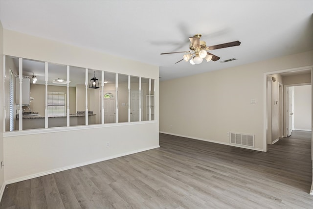 spare room with ceiling fan and wood-type flooring