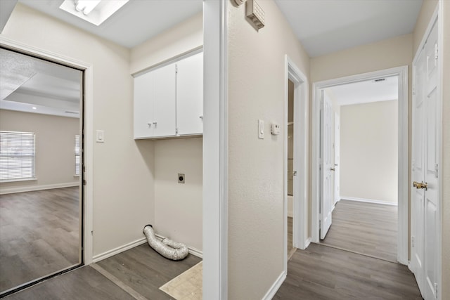 hallway featuring light wood-type flooring and a skylight