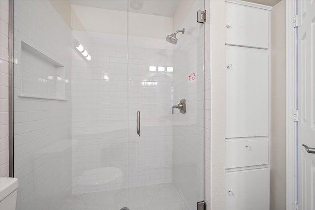 bathroom with toilet and walk in shower