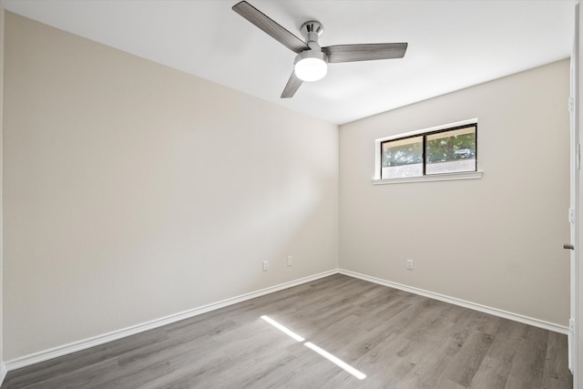 spare room with ceiling fan and wood-type flooring