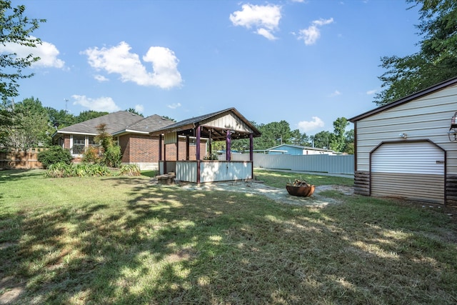 view of yard featuring an outdoor fire pit and an outbuilding