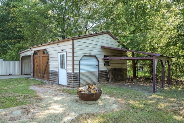 view of outbuilding with an outdoor fire pit