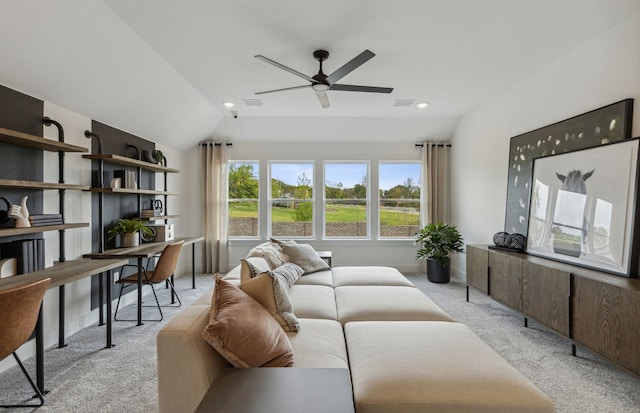 carpeted living room featuring ceiling fan and vaulted ceiling