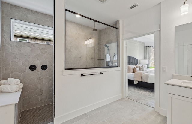 bathroom featuring vanity and a tile shower