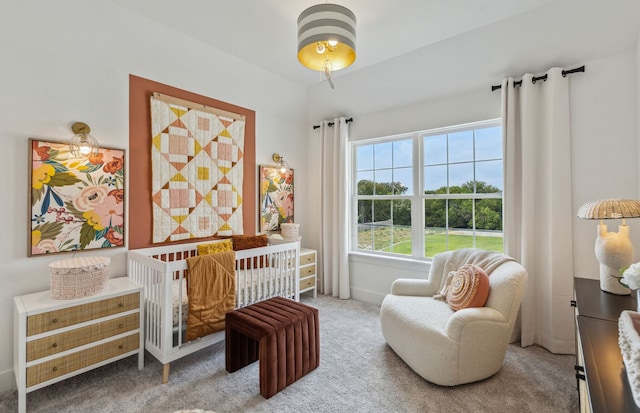 bedroom featuring carpet flooring and a crib