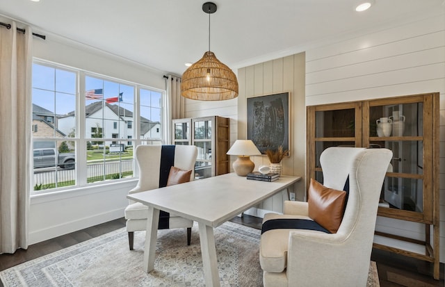 office space featuring dark hardwood / wood-style flooring, wooden walls, and ornamental molding