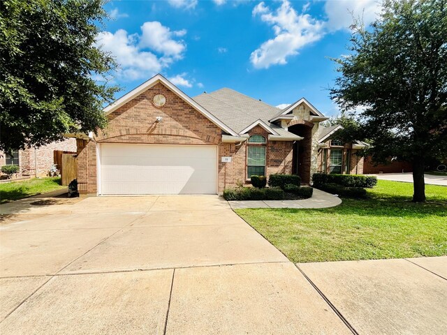 view of front of home with a front yard and a garage