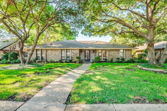 ranch-style house featuring a front yard and brick siding